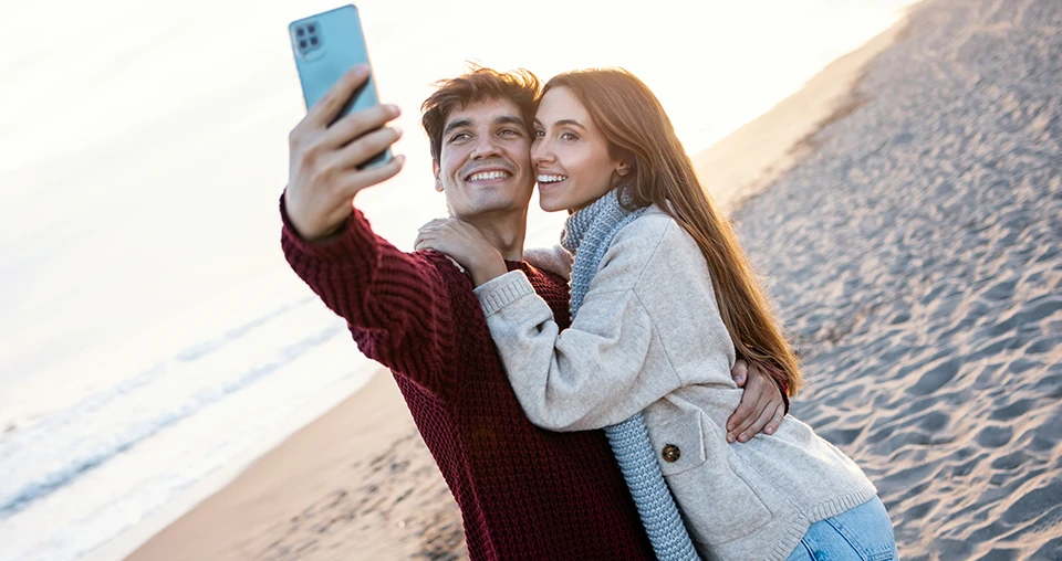 Couple on the beach taking a selfie