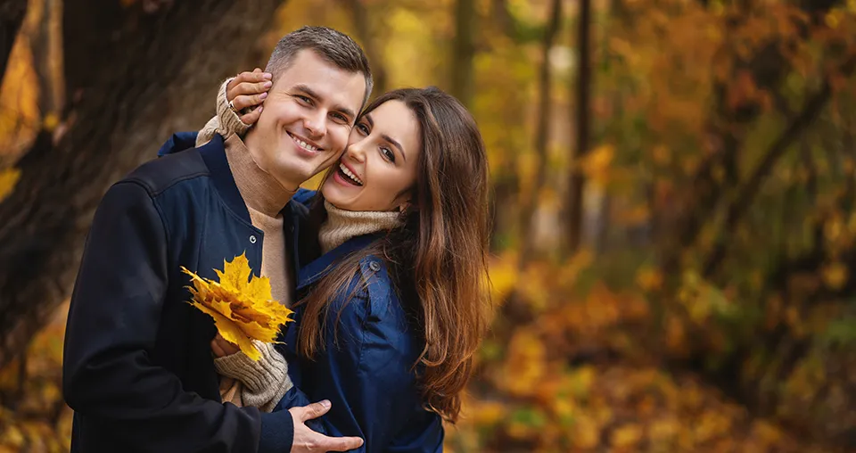 couple enjoying an autumn walk in the woods