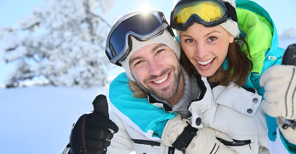 happy couple cross country skiing